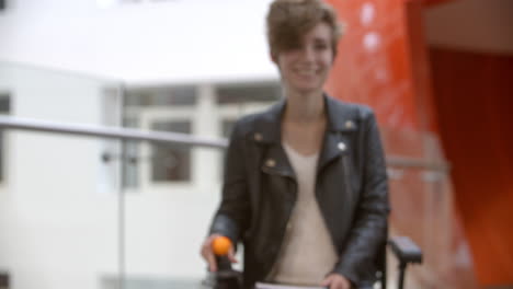 Female-university-student-in-a-wheelchair-moving-into-focus