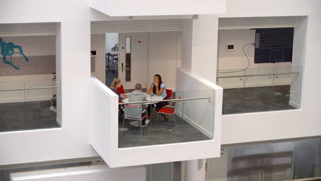 Students-socialise-on-a-mezzanine-in-a-university-building