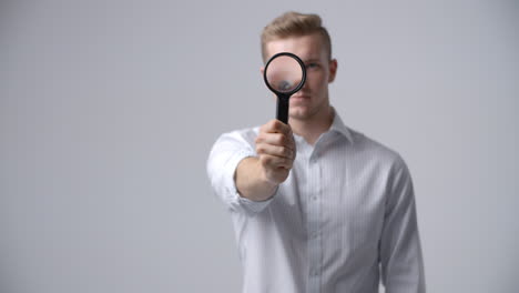 Slow-Motion-Shot-Of-Male-Criminologist-With-Magnifying-Glass