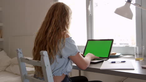Teenage-girl-using-phone-and-computer-in-her-bedroom,-shot-on-R3D