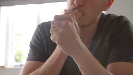 Slow-Motion-Of-Young-Man-Lighting-Joint-At-Home