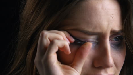 Studio-Portrait-Shot-Of-Unhappy-Woman-With-Smudged-Make-Up