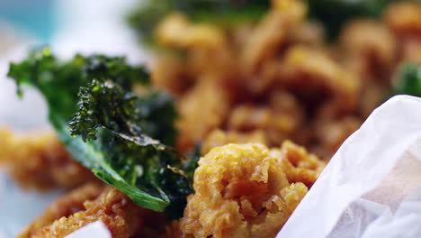 Fried-baby-squid-with-kale,-extreme-close-up,-rack-focus