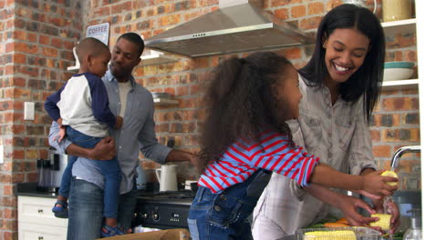 Children-Helping-Parents-To-Prepare-Meal-In-Kitchen