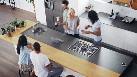 Overhead-View-Of-Friends-Drinking-Coffee-In-Modern-Kitchen