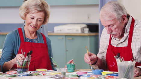Two-Retired-Seniors-Attending-Art-Class-In-Community-Centre