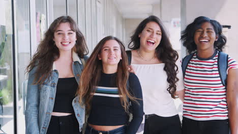 Portrait-Of-Smiling-Female-University-Student-Friends-In-Corridor-Of-Building