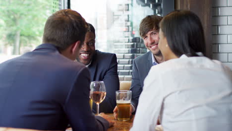 Group-Of-Business-Colleagues-Meeting-For-Drinks-And-Socializing-In-Bar-After-Work
