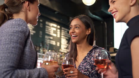 Group-Of-Female-Friends-Meeting-For-Drinks-And-Socializing-In-Bar-After-Work