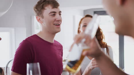 Group-Of-College-Students-In-Shared-House-Kitchen-Hanging-Out-And-Drinking-Together