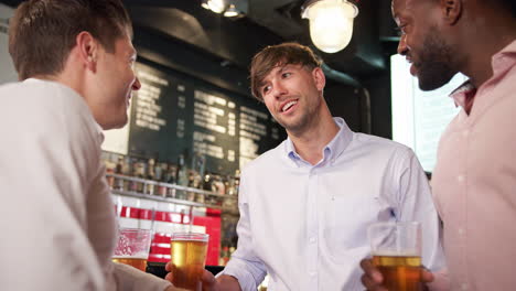 Group-Of-Men-Meeting-For-Drinks-And-Socializing-In-Bar