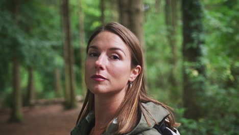 Head-And-Shoulders-Portrait-Of-Woman-Hiking-Through-Woodland
