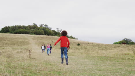 Rear-View-Of-Group-Of-Children-On-Outdoor-Activity-Camping-Trip-Running-Up-Hill