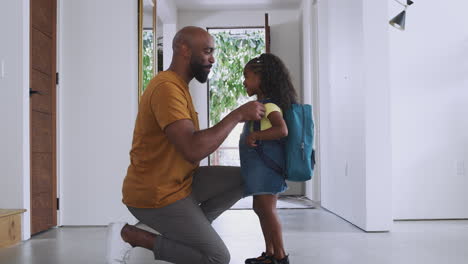 Father-Saying-Goodbye-To-Daughter-As-She-Leaves-Home-For-School