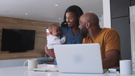 African-American-Family-With-Baby-Daughter-Using-Laptop-To-Check-Finances-At-Home