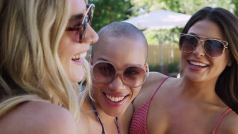 Group-Of-Smiling-Female-Friends-Outdoors-Relaxing-And-Enjoying-Summer-Pool-Party