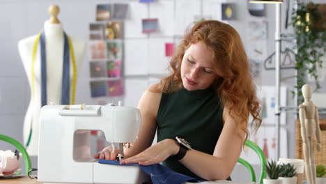 Female-Student-Or-Business-Owner-Working-In-Fashion-Industry-Using-Sewing-Machine-In-Studio