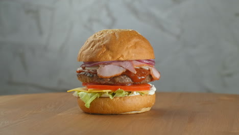 A-delicious-cheeseburger-served-on-a-wooden-platter.