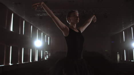 Arts-and-entertainment-in-theatre-with-female-classic-dancer-in-tutu-standing-behind-the-scenes-and-looking-at-stalls