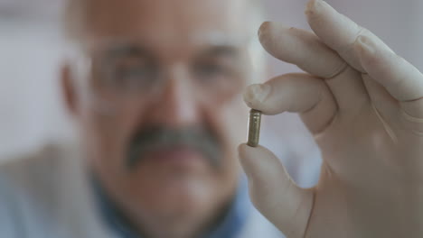 An-elderly-scientist-man-holds-a-green-tablet-close-up-shot.-Development-of-drugs-for-diabetes-and-coronavirus.-High-quality-4k-footage