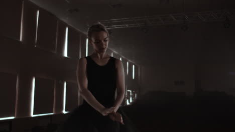 Silhouette-of-young-ballet-dancer-standing-back-to-camera.-Light-silhouette-of-elegant-young-ballerina-standing-back-to-camera-in-second-position-arms-pose-on