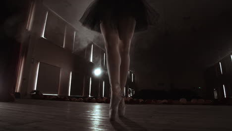 Close-up-Shot-of-Ballerina's-Legs.-She-Dances-on-Her-Pointe-Ballet-Shoes.-She's-Wearing-Black-Tutu-Dress.-Shot-in-a-Bright-and-Sunny-Studio.-In-Slow-Motion.