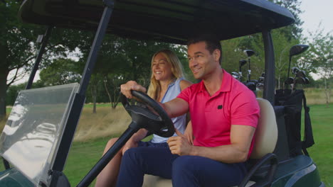 Close-Up-Of-Couple-Driving-Buggy-Playing-Round-On-Golf-Together