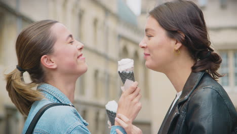 Same-Sex-Female-Couple-Sightseeing-And-Eating-Ice-Creams-As-They-Walk-Around-Oxford-UK-Together