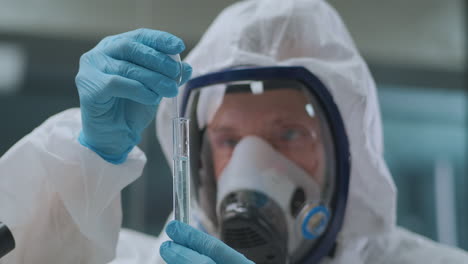 crime-expert-is-researching-chemical-in-test-tube-in-chemistry-laboratory-portrait-of-male-scientist-with-dangerous-reagent