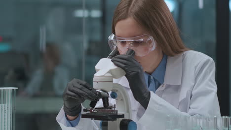 expert-witness-woman-is-researching-analysis-and-evidences-in-laboratory-looking-into-microscope-forensic-expert-practice