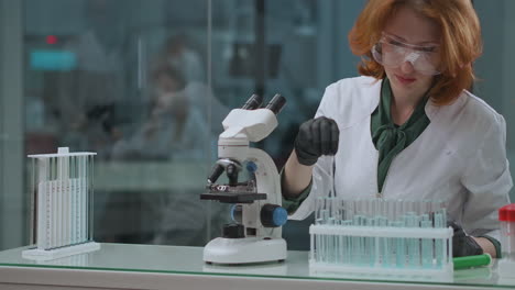 Laboratorio-De-Experiencia-Ecológica-Mujer-Especialista-Está-Revisando-Muestras-De-Agua-Tóxicas-Y-Peligrosas-Usando-Un-Microscopio-Para-Investigar-Un-Laboratorio-Científico-Con-Equipos-Modernos