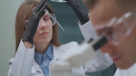 laboratory-of-quality-control-on-production-factory-chemical-and-ecological-expertise-female-technician-is-looking-and-researching-sample