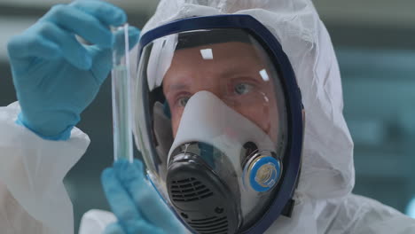 virologist-is-holding-in-hands-tube-with-vaccine-from-covid-19-closeup-of-human-face-in-laboratory-pandemic-of-coronavirus