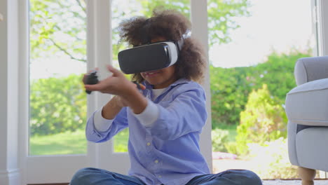 Boy-Sitting-On-Floor-In-Lounge-Wearing-VR-Headset-Playing-Shooting-Computer-Game