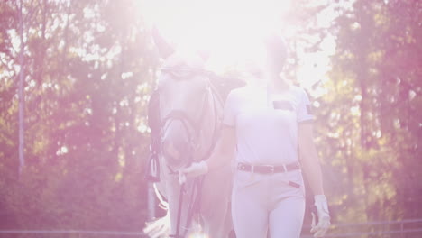 Horsewomen-with-her-favorite-horse-on-the-walk-before-professional-training-in-the-horse-club.-Lovely-hobby-and-sport-for-amazing-life.