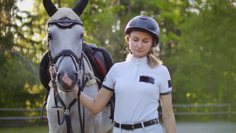 One-walk-from-professional-horsewomen-and-her-lovely-white-horse-in-the-nature