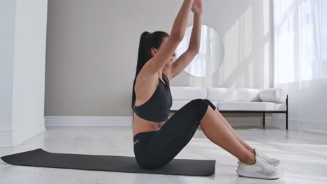 Home-fitness-concept.-Woman-doing-abs-crunches-on-floor-at-home-copy-space