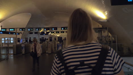 Mum-with-baby-walking-to-subway-turnstile-in-Lisbon-Portugal