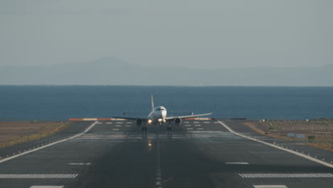 Aircraft-successful-landing-on-runway-overlooking-sea