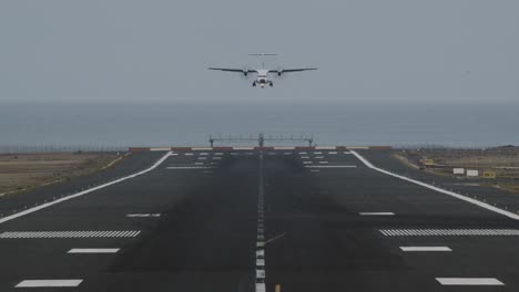 An-airport-runway-with-a-landing-plane