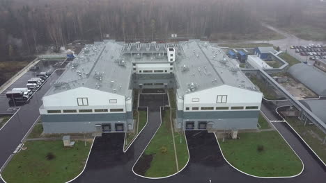 An-aerial-view-of-two-industrial-buildings-in-a-snowfall