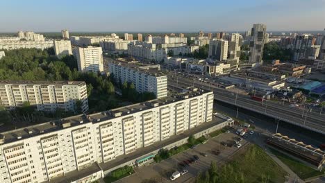 An-aerial-view-of-a-multi-storey-area-and-a-highway-in-the-middle-of-it