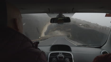 A-slowmotion-view-from-a-windshield-of-a-car-moving-past-the-volcanic-rock