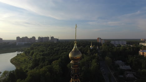 Aerial-cityscape-at-sunset-with-golden-dome-of-Orthodox-church-Russia