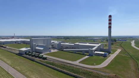 An-aerial-view-of-a-white-factory-building-in-green-fields