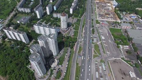 An-aerial-view-of-a-busy-highway-next-to-the-multi-storey-district