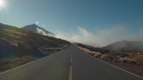 Landscape-with-mountain-road-and-sailing-clouds-Tenerife