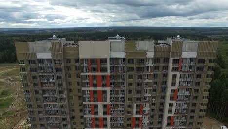 A-vertical-inspection-of-a-multi-storey-building-being-built-against-the-green-landscape