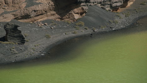 Agua-Verde-Del-Lago-El-Golfo-Con-Arena-Volcánica-Negra-Alrededor-De-La-Vista-De-Lanzarote.