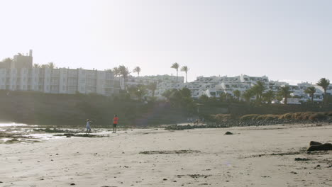 Boy-is-a-stone-thrower-Beach-scene-with-hotels-in-Lanzarote